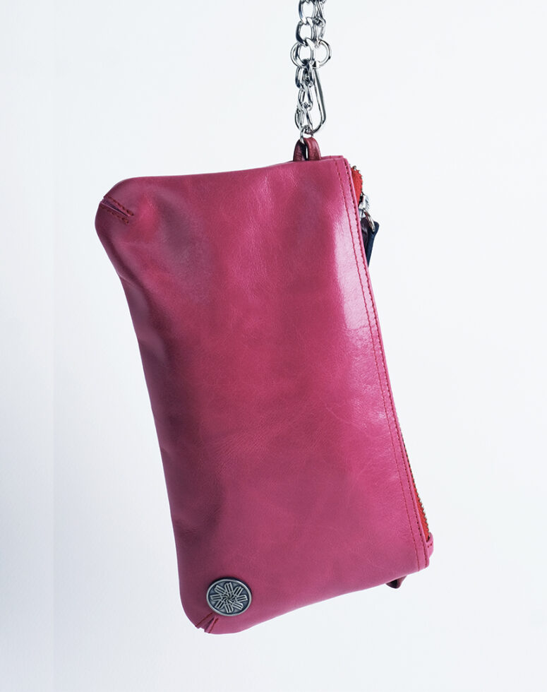 The Partout is a small genuine leather clutch bag that be carried around your shoulder or around your wrist.