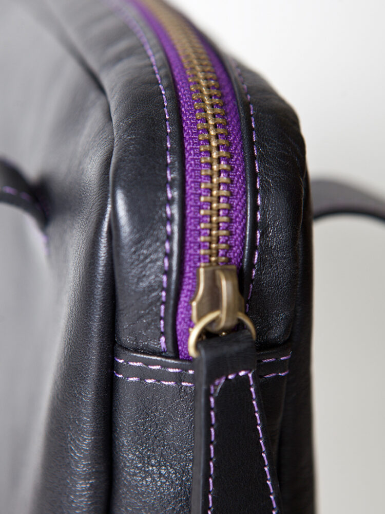 The elegent Baby Jud leather handbag with a colored brass zipper.