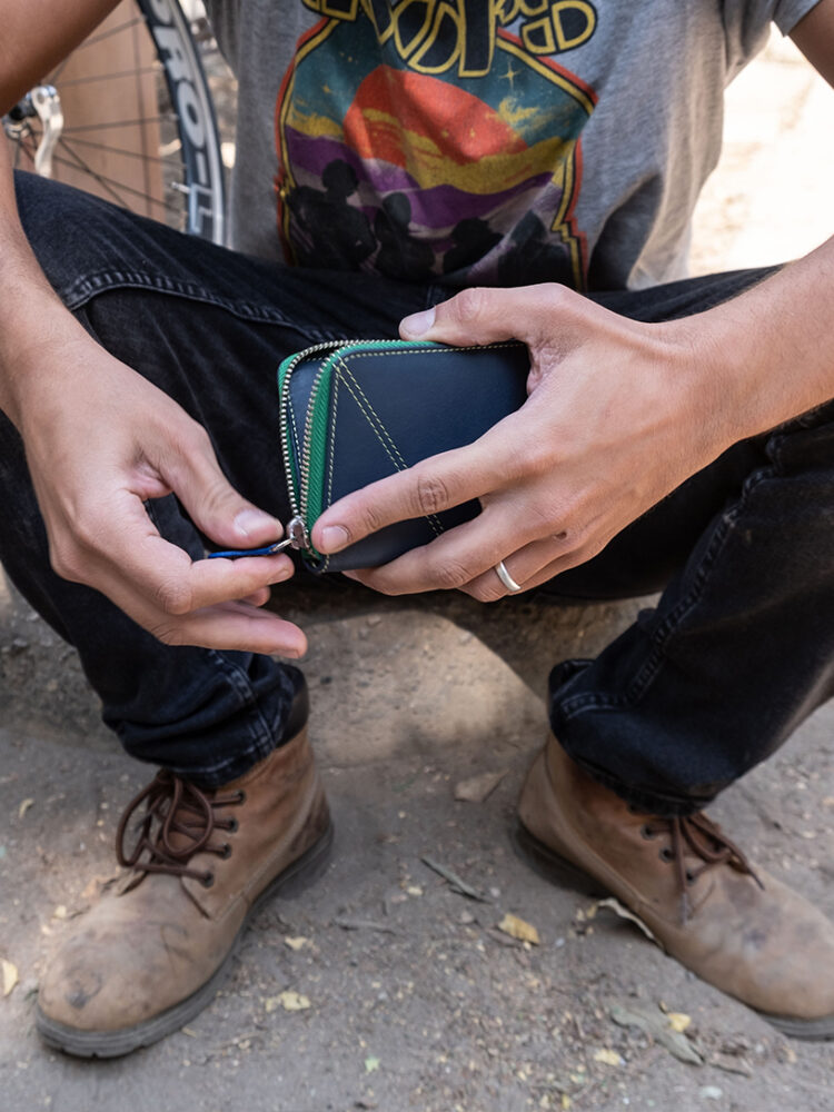 The Most wallet's all-round zipper keeps everything safe inside your wallet. Irregular stitching on the front gives this wallet its MakladWali stamp.